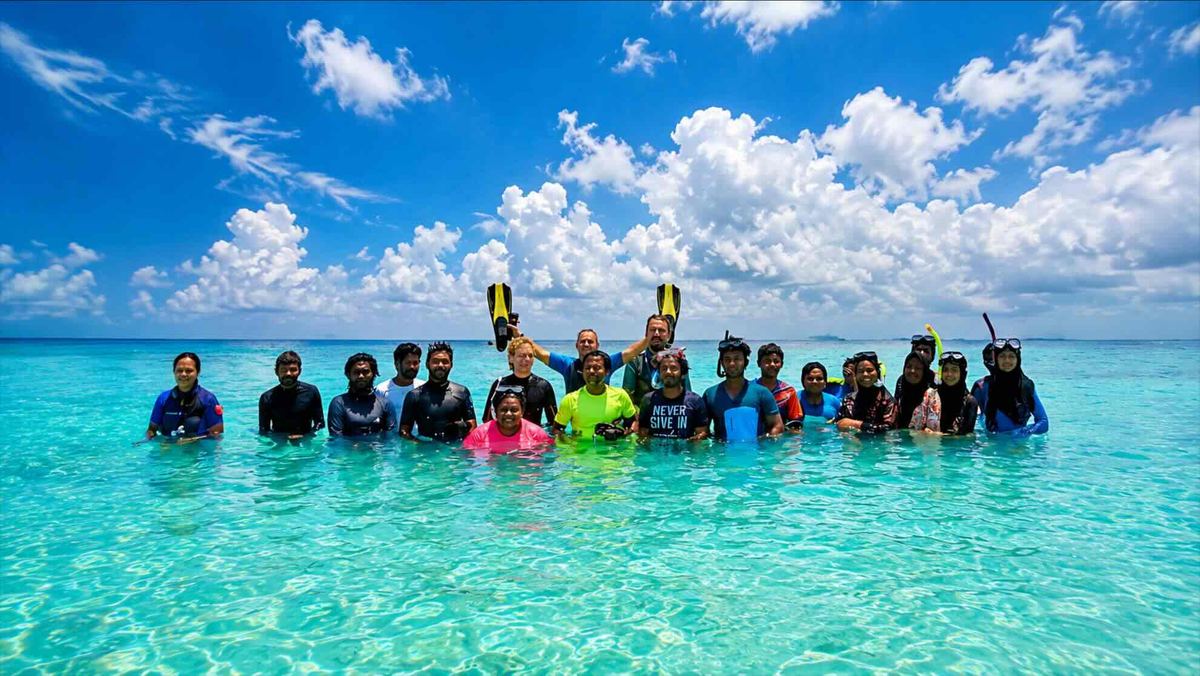 A group of coral gardeners together in the water after a training session